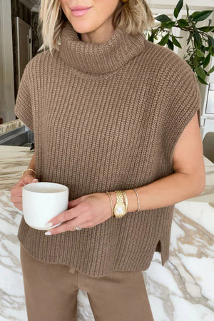 Sleeveless ribbed turtleneck sweater in taupe, with a relaxed fit and side slits.