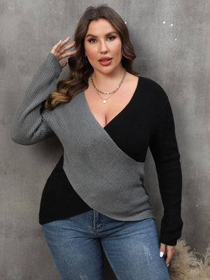 Colorblock crossover knit sweater in dark gray and black acrylic with a deep V-neck.