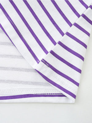Baby dress with purple and white stripes, cotton fabric, close-up of hem and seams.