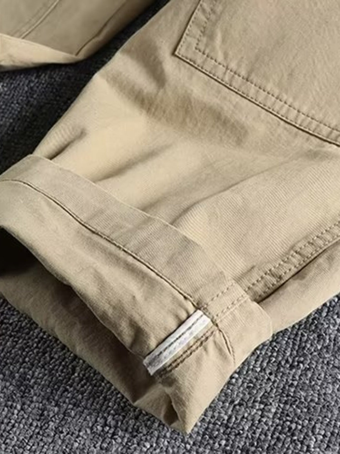 Khaki cargo pants with elastic waist and cuffed hem detail.
