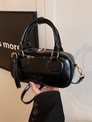 Black mini crossbody bag in shiny PU leather with top handles and gold hardware