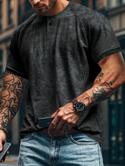 Textured black henley tee with raglan sleeves and button placket.