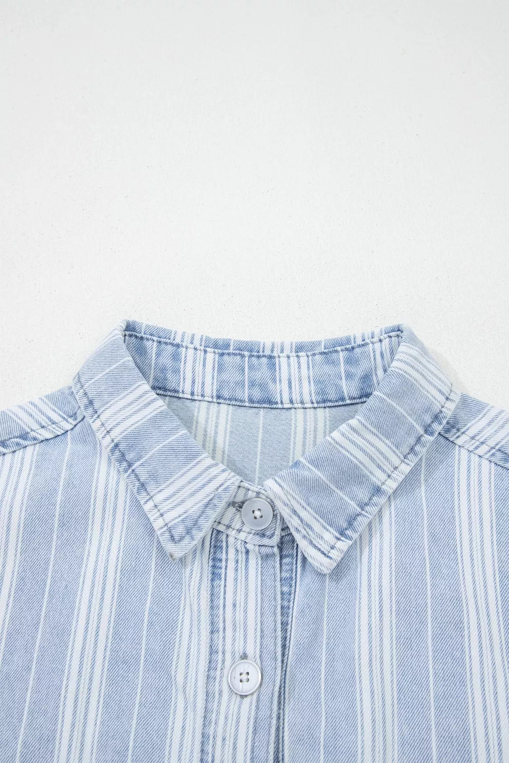 Denim shacket with vertical white stripes, button-down collar, and button closure.