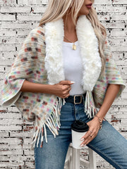 Textured plaid acrylic poncho with faux fur collar and fringe details.