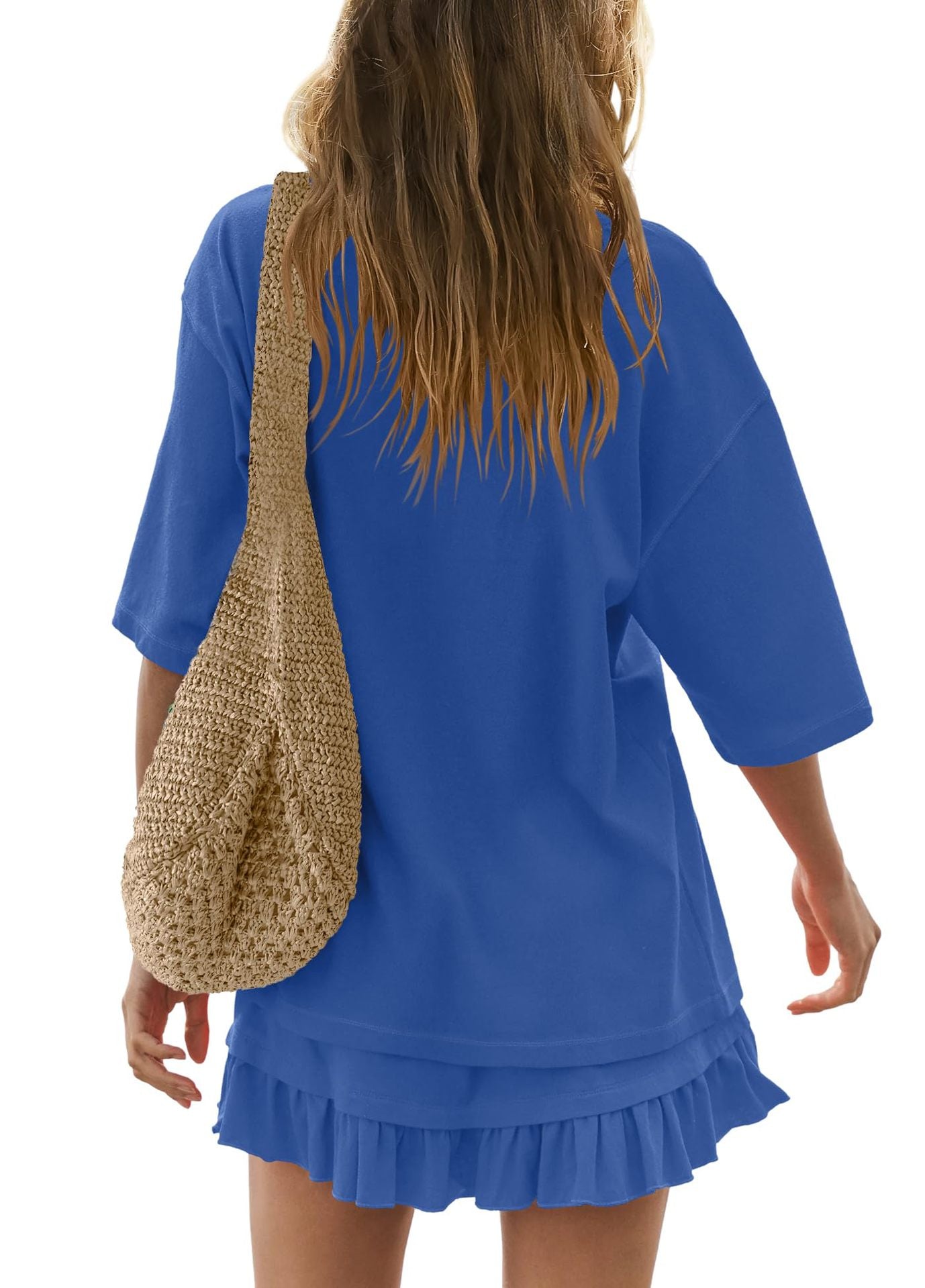 Sapphire blue ruffled tee and skirt set with relaxed fit and short sleeves, styled with a woven bag.