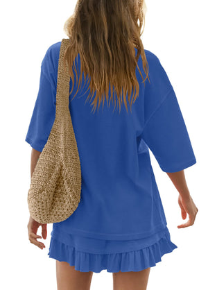 Sapphire blue ruffled tee and skirt set with relaxed fit and short sleeves, styled with a woven bag.