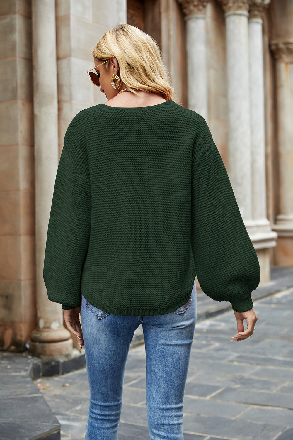 Army green ribbed knit sweater with balloon sleeves and a rounded hem.