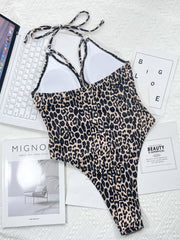 Leopard print one-piece swimsuit with ring detail and halter neck.