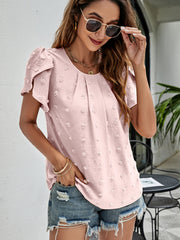 Pink textured puff sleeve blouse with dot pattern and gathered neckline.