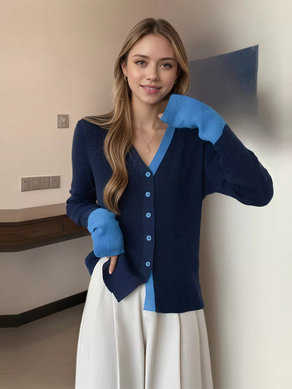 Navy ribbed cardigan with sky blue contrast trim and sleeves, buttoned front.