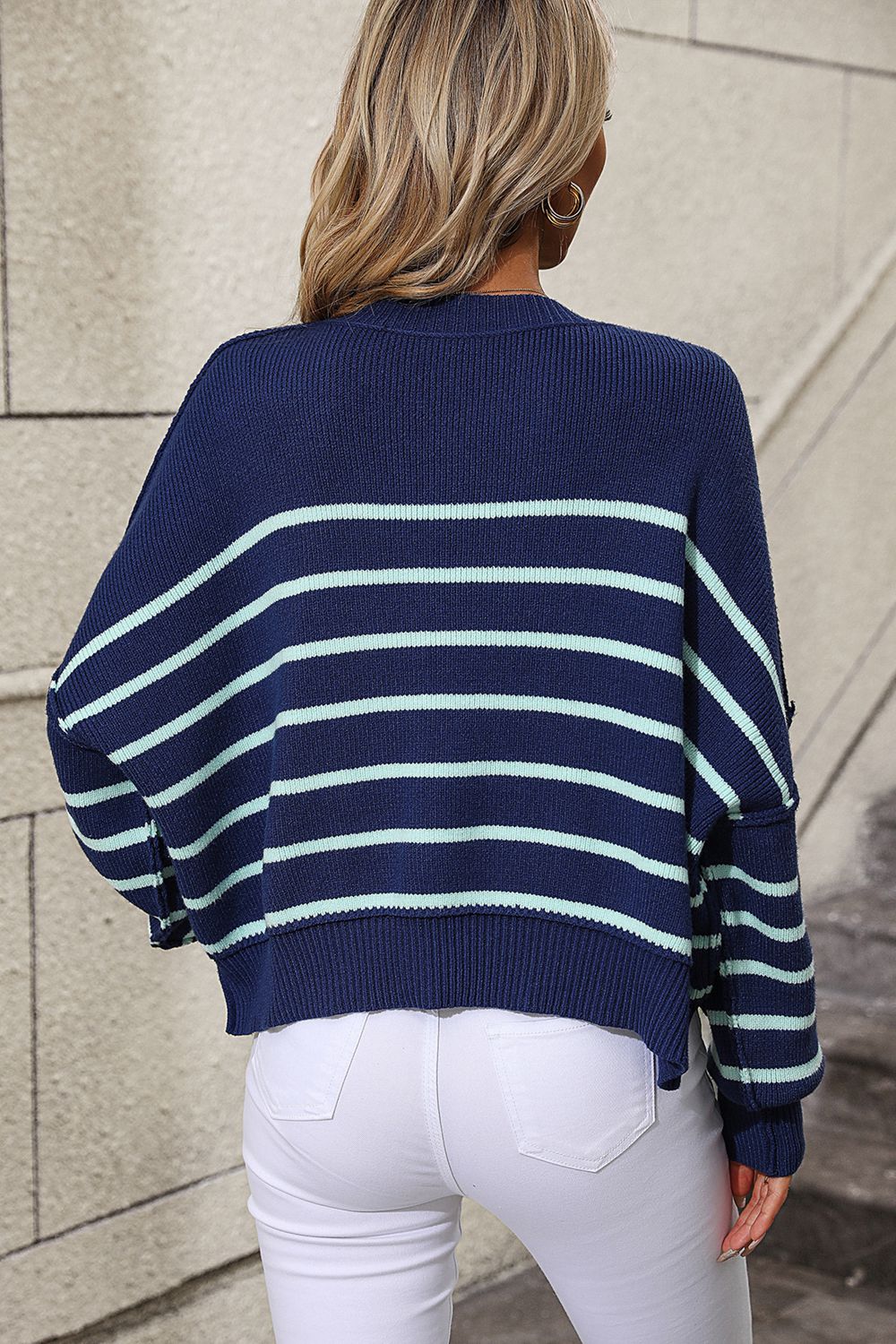Navy and aqua striped boxy knit sweater with crew neck and relaxed fit.