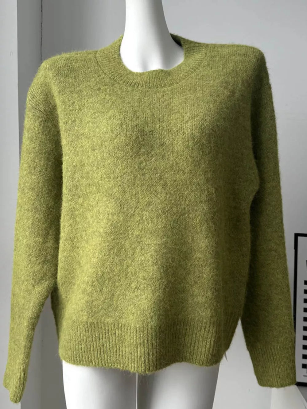 Moss green knit sweater with crew neck and relaxed fit