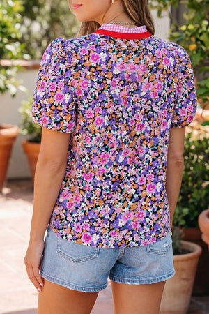 Floral print polyester shirt with puff sleeves, V-neck, and red gingham trim.