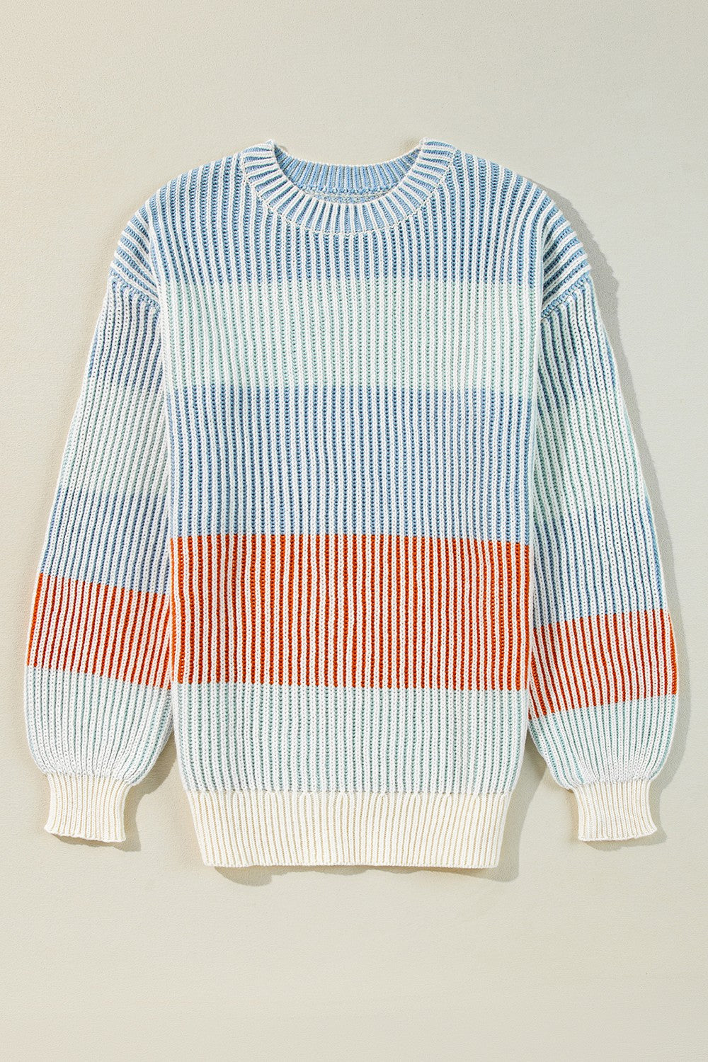 Ribbed stripe knit sweater with balloon sleeves in blue, tan, and dusty pink hues.