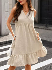 Khaki V-neck sleeveless dress with ruffle hem and pockets, textured fabric.
