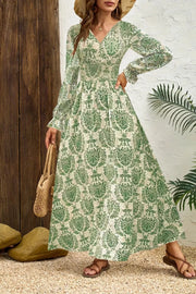 Sage printed maxi dress with bishop sleeves, cinched waist, and V-neck.