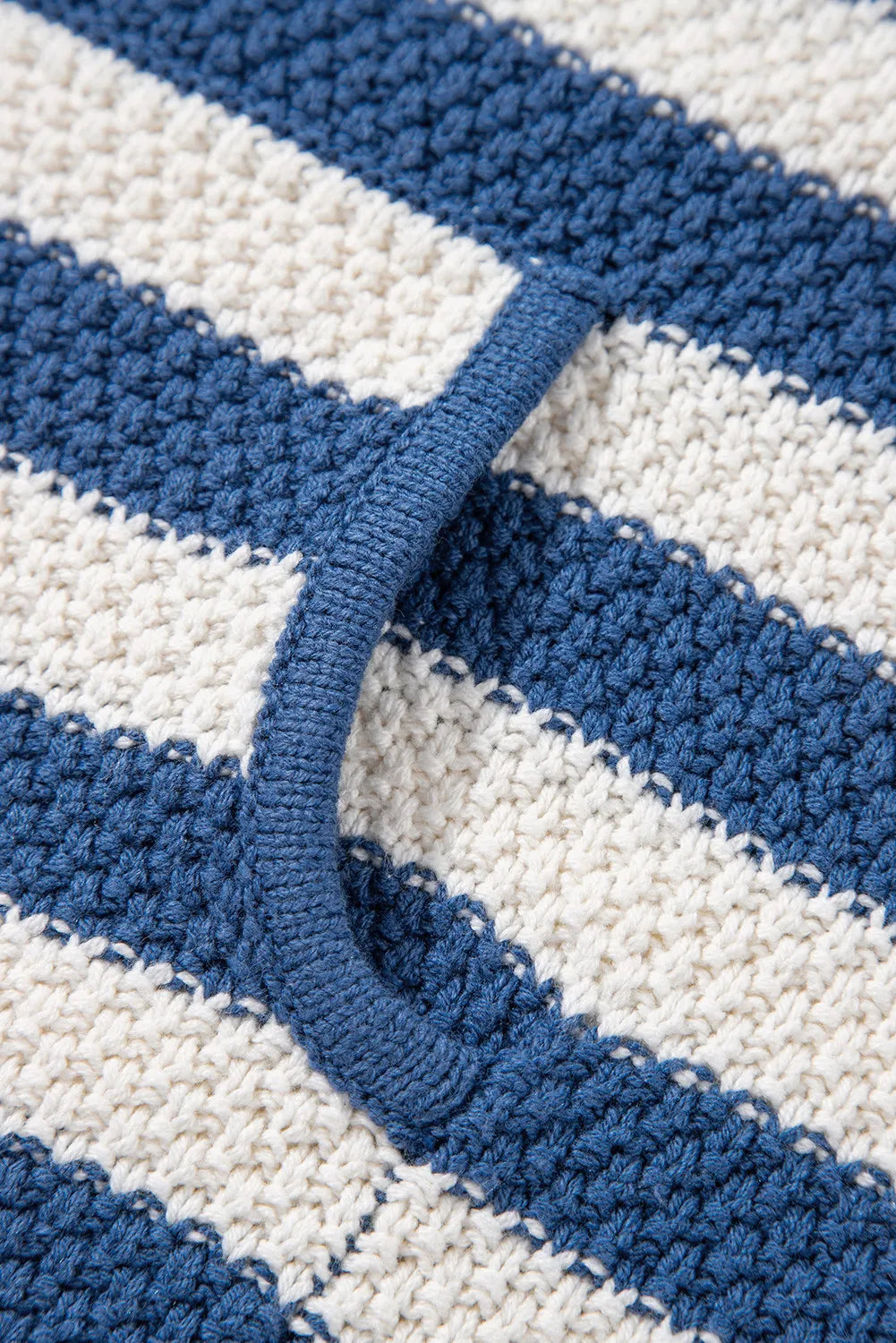 Textured knit hoodie in peacock blue and white stripes with a pouch pocket detail.