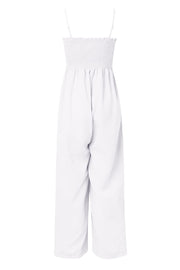 White smocked bodice palazzo jumpsuit with wide leg pants and spaghetti straps.