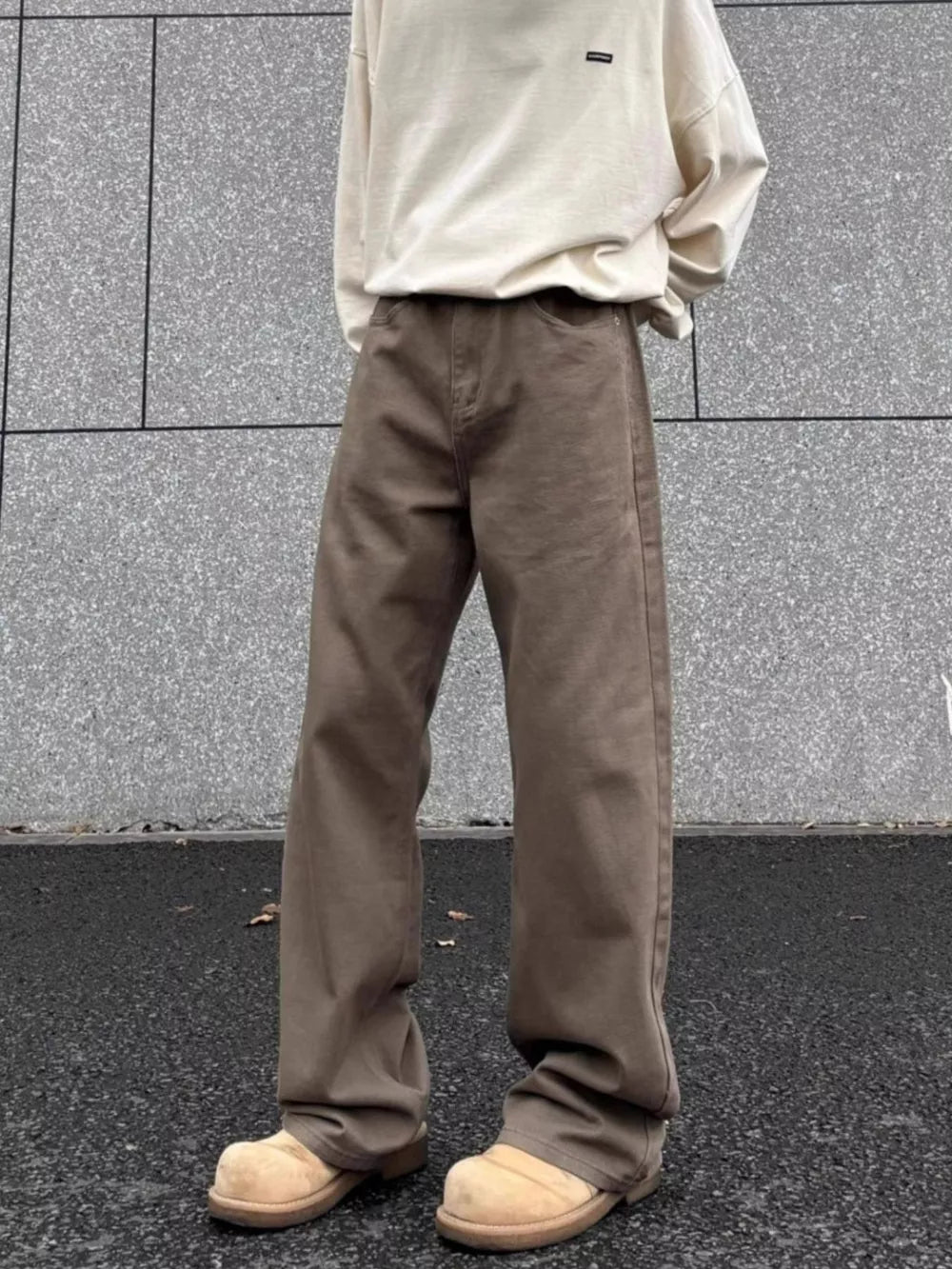 Men's brown wide-leg sweatpants with a relaxed fit and drawstring waist.
