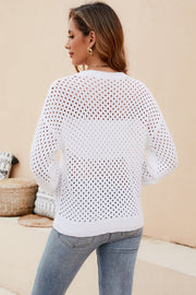 White open-knit crewneck sweater with subtle texture and long sleeves.