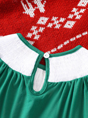 Green A-line baby dress with smocked white yoke, keyhole back, and festive red knit overlay.
