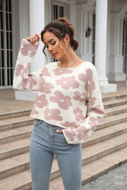 Blush pink floral intarsia cropped knit sweater with crew neck and long sleeves.
