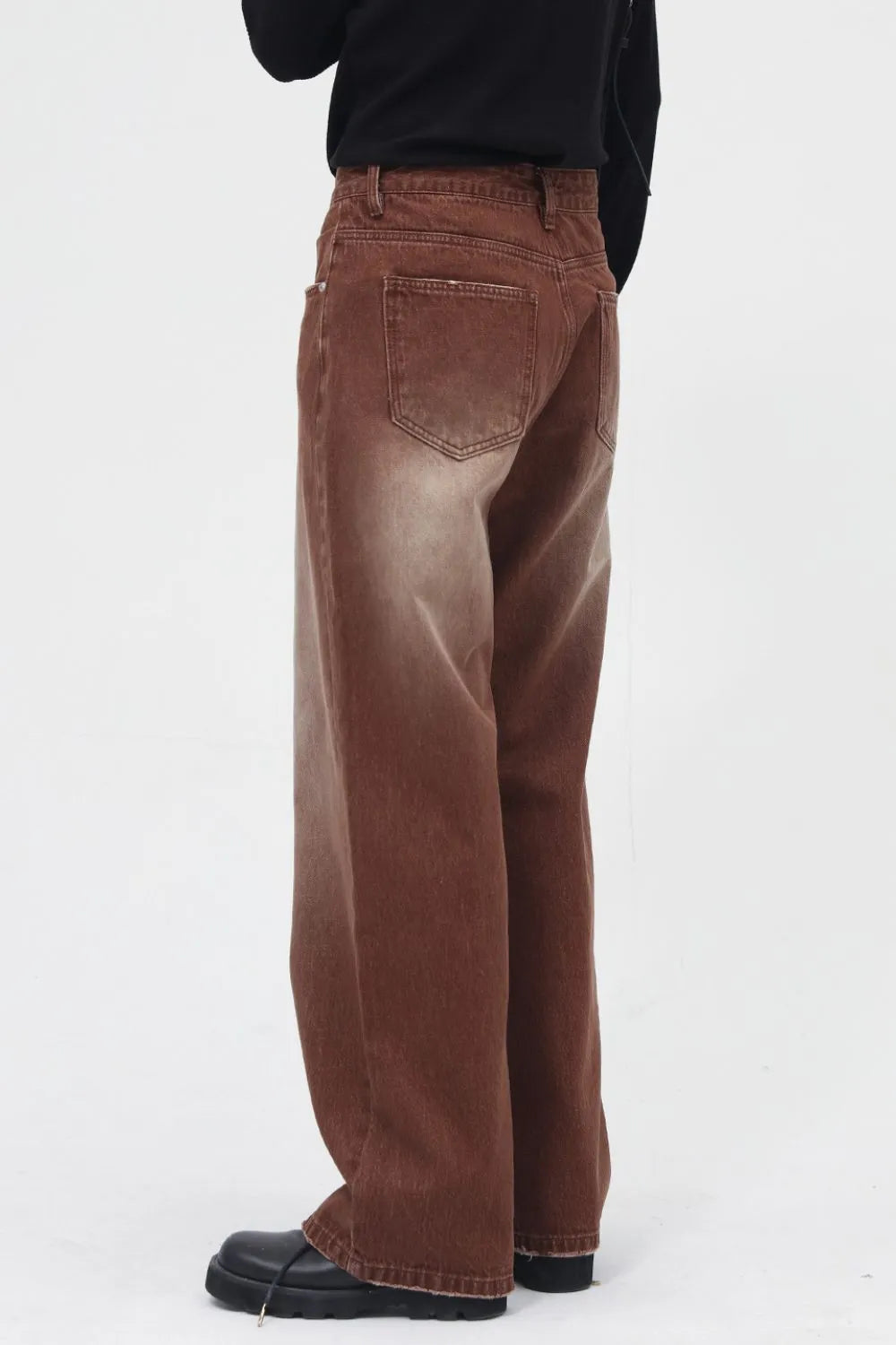 Brown faded wash wide leg denim trousers with a relaxed fit.