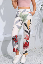 Botanical print slim-fit trousers in floral pattern, featuring a high waist and ankle length.