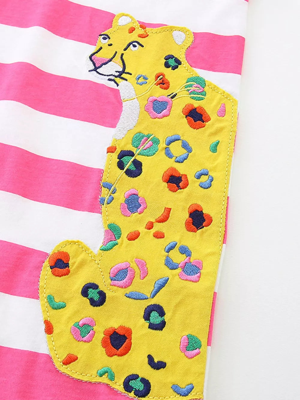 Toddler dress with pink and white stripes and a yellow leopard applique with colorful embroidered spots.