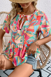 Multicolor geometric print peplum blouse with tassels, casual chic style.