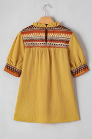 Mustard blouse with embroidered yoke and puff sleeves.