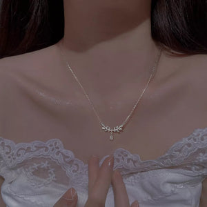 Elegant silver zircon flower pendant necklace with delicate leaf design and a single teardrop crystal.