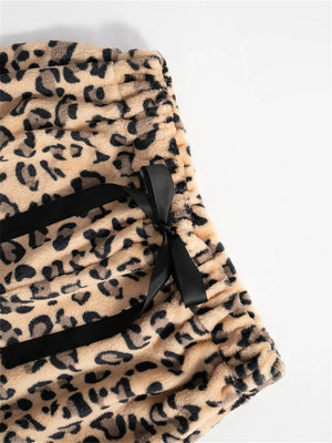 Leopard print lounge palazzo trousers with black bow detail and satin trim.