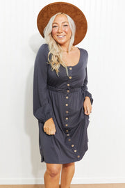 Gray button-down empire waist mini dress with long sleeves and a scoop neckline.