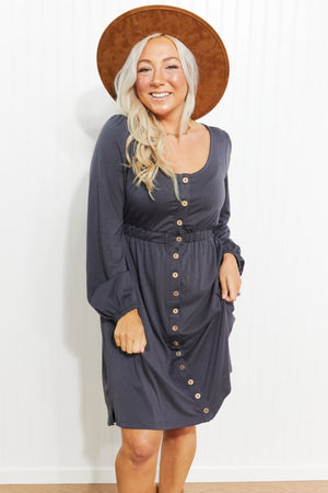Gray button-down empire waist mini dress with long sleeves and a scoop neckline.