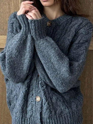 Gray cable-knit button-down cardigan with round neckline and wooden buttons.