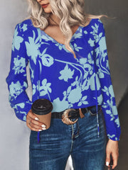 Cobalt floral tie-neck blouse with long sleeves and a v-neck.