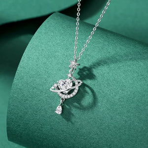Celestial heart pendant necklace with star and planet design, silver tone, cubic zirconia accents.