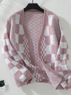 Dusty pink and white checkerboard knit open-front cardigan with textured sleeves.