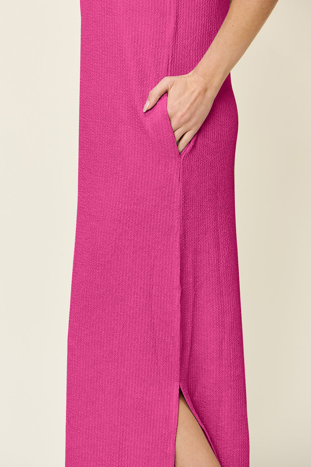 Hot pink ribbed maxi dress with side slits and pockets.