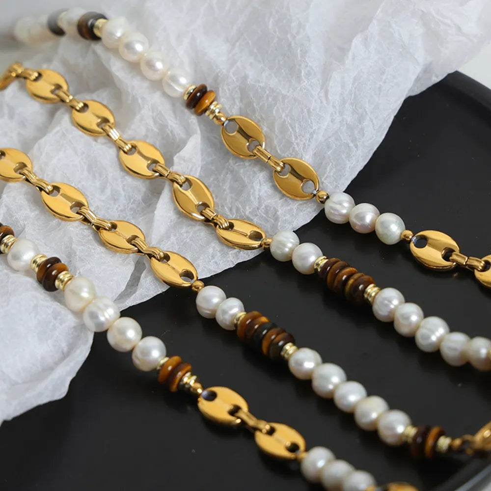 Gold link bracelet with pearls and tiger's eye beads