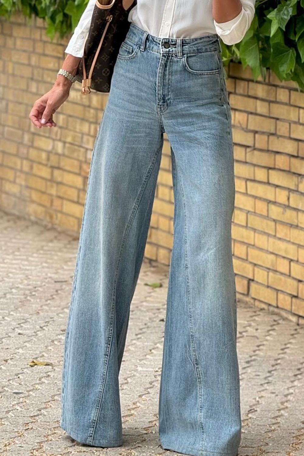 High-waisted palazzo flare denim jeans in medium wash, wide leg.