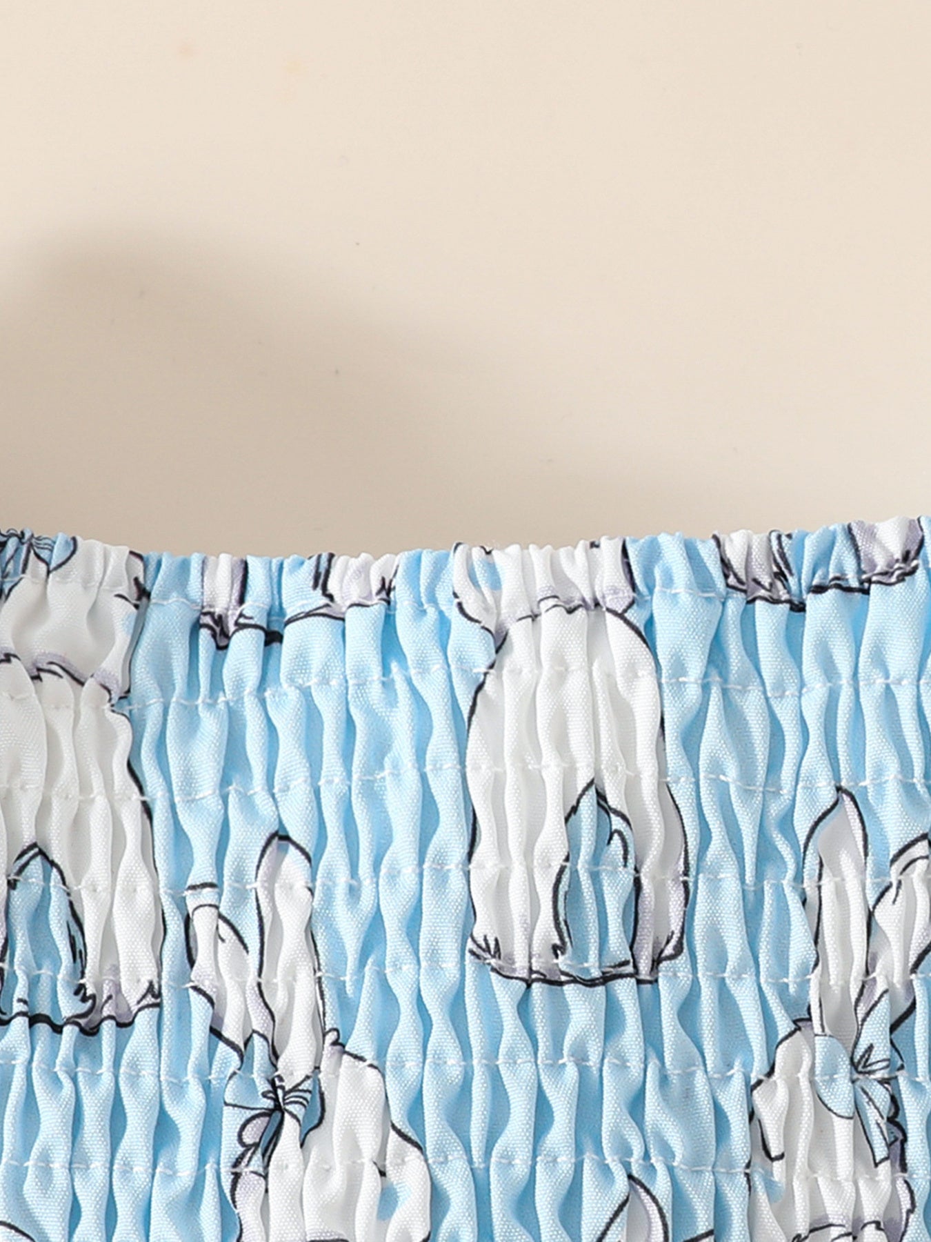 Baby dress with smocked bodice in sky blue with white bunny print
