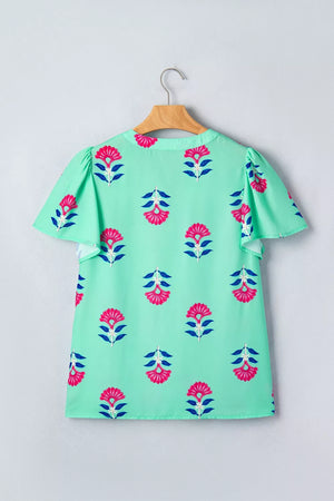 Mint green blouse with pink floral print, V-neck, and flutter sleeves.