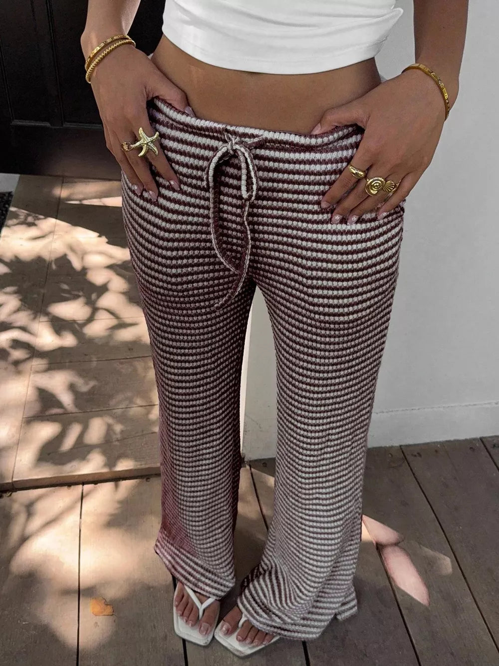 Striped wide leg maternity pants in dark brown with drawstring waist.