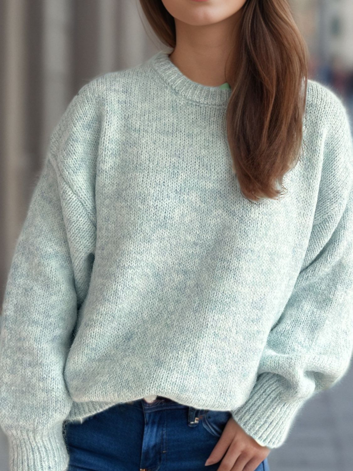 Oversized light green crewneck sweater with textured knit and ribbed cuffs.
