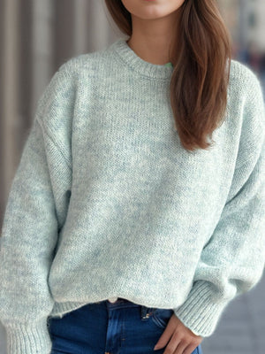 Oversized light green crewneck sweater with textured knit and ribbed cuffs.