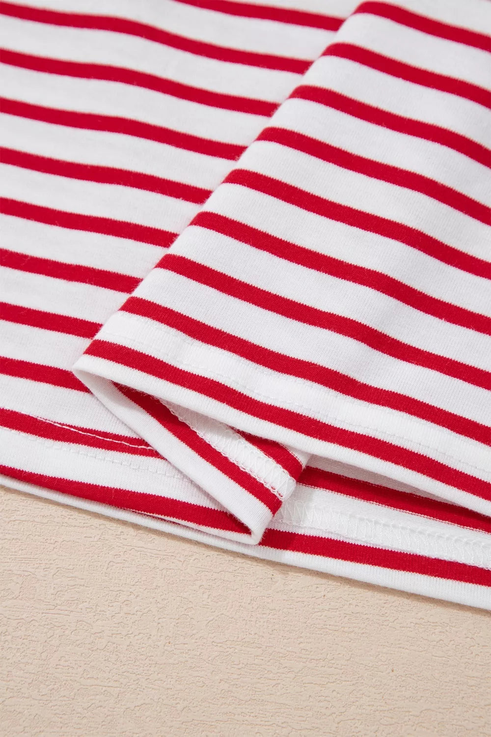 Maternity shirt with red and white stripes, cotton fabric, puff sleeve detail visible.
