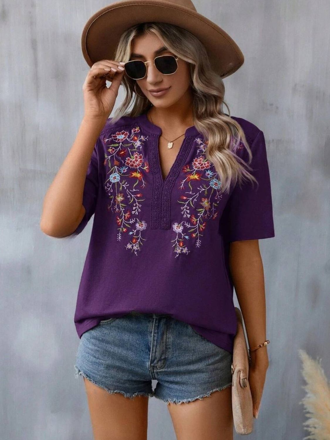 Violet embroidered V-neck tunic with crochet trim and short sleeves.