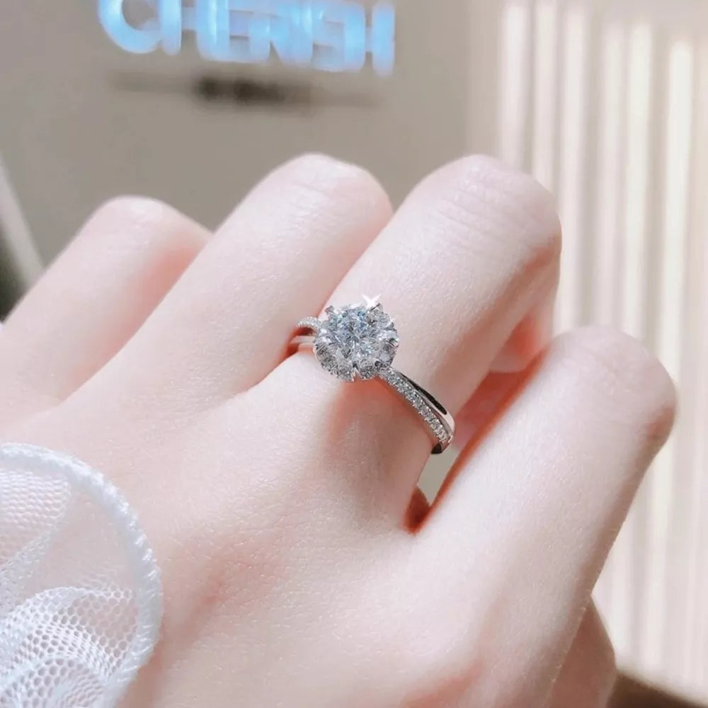 Brilliant moissanite ring in sterling silver with pave band.